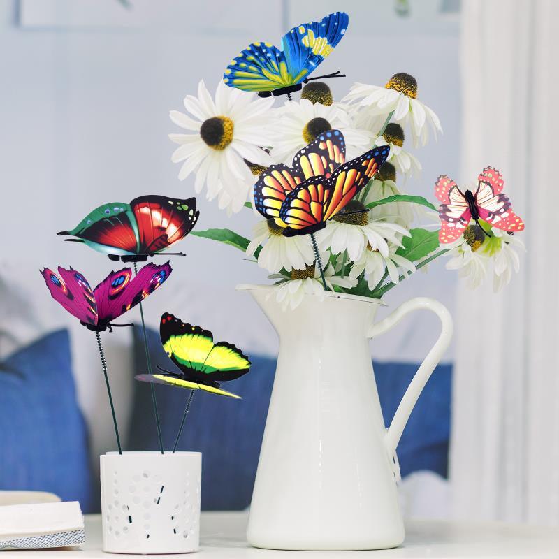 Bouquet de papillons multicolore avec des fleurs blanches dans un vase en céramique, ajoutant une touche colorée à votre décoration
