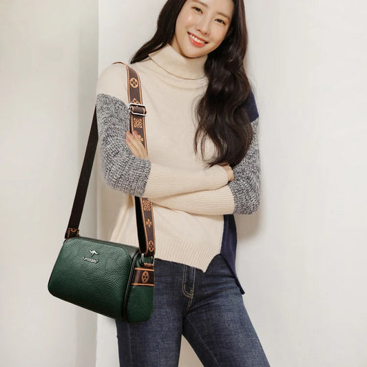 Sac bandouliere cuir femme, élégant et pratique, porté par une femme souriante avec un pull beige et jeans.