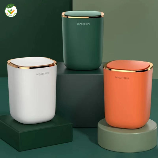 Poubelle automatique de luxe en blanc, vert et orange avec finition dorée, idéale pour un intérieur moderne