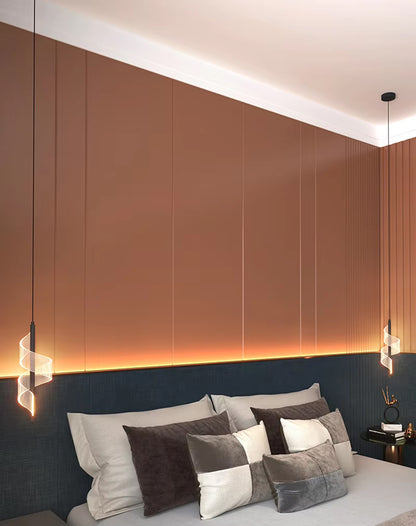 Plafonnier LED nordique élégant suspendu au-dessus d'un lit moderne avec des coussins décoratifs