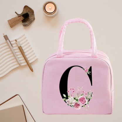 Sac isotherme rose avec motif floral et initiale stylisée, parfait pour le déjeuner et les pique-niques