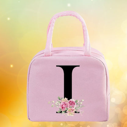 Sac isotherme rose élégant avec des fleurs et une lettre 'L' sur le devant, idéal pour le lunch