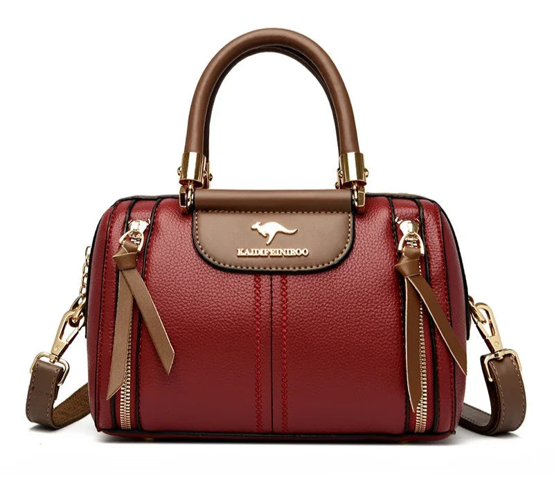 Sac femme style haut de gamme en cuir haut de gamme, couleur rouge avec finitions dorées et anses élégantes.
