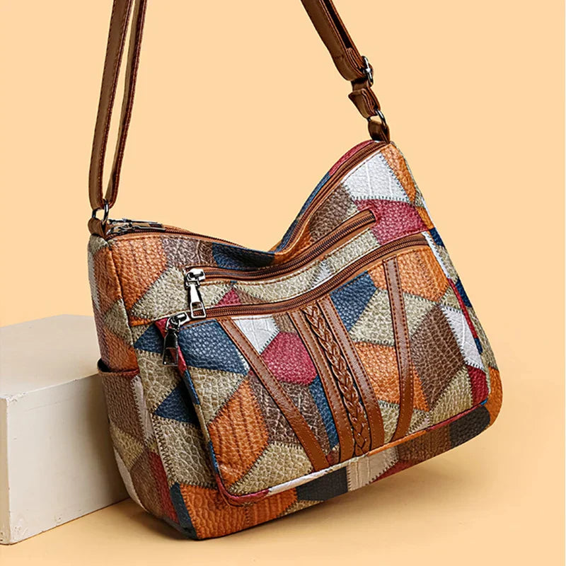 Sac bandoulière femme en cuir vintage avec motifs géométriques aux couleurs variées et doublure zippée